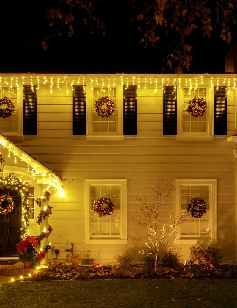 House with icicle lights and wreaths
